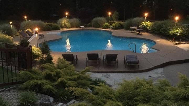 Custom in ground pool build at night in St Louis County Missouri