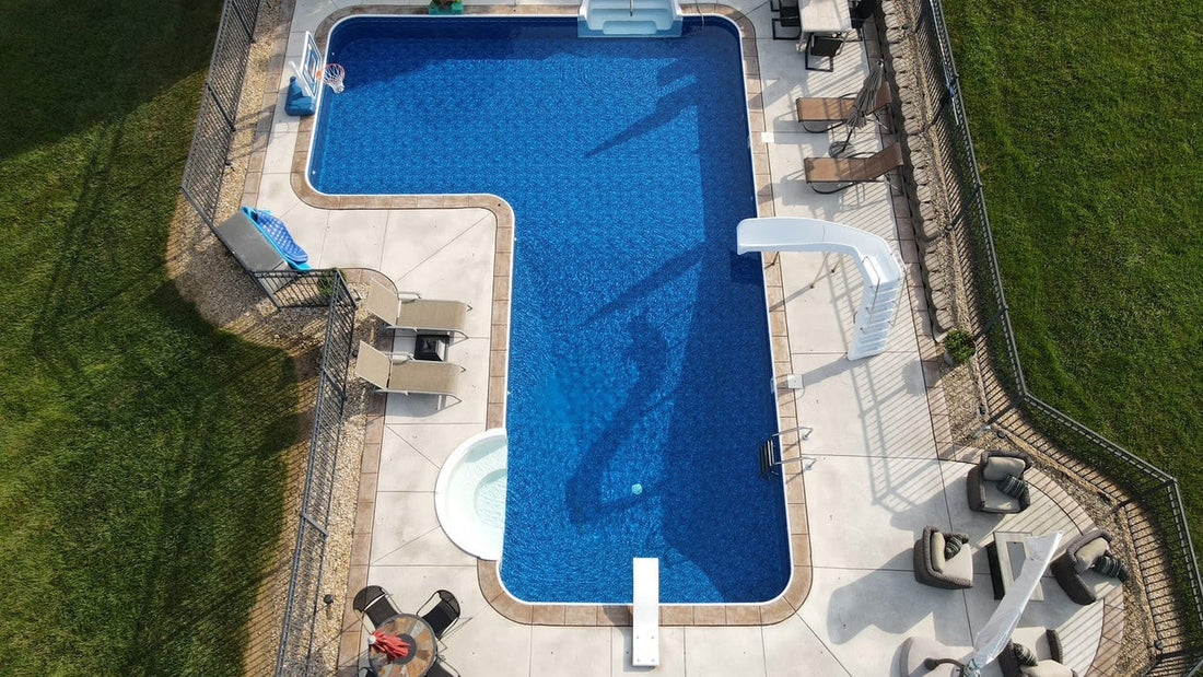 Custom pool installation with diving board and slide in St. Louis Missouri residential backyard